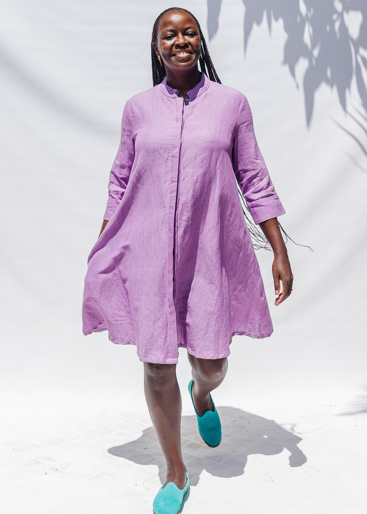 The model is wearing lavender dress