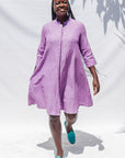 The model is wearing lavender dress