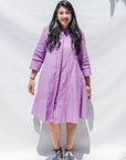 The model is wearing lavender dress