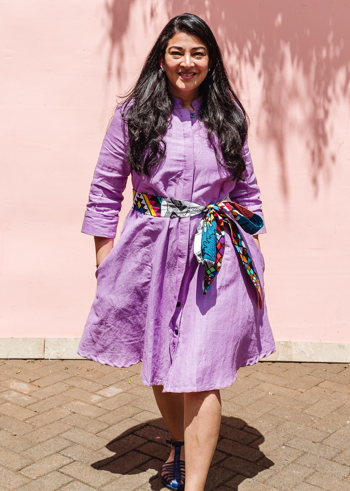 The model is wearing lavender dress