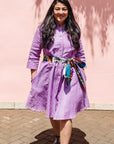 The model is wearing lavender dress