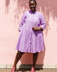 The model is wearing lavender dress