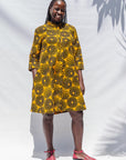  The model is wearing black, yellow print dress