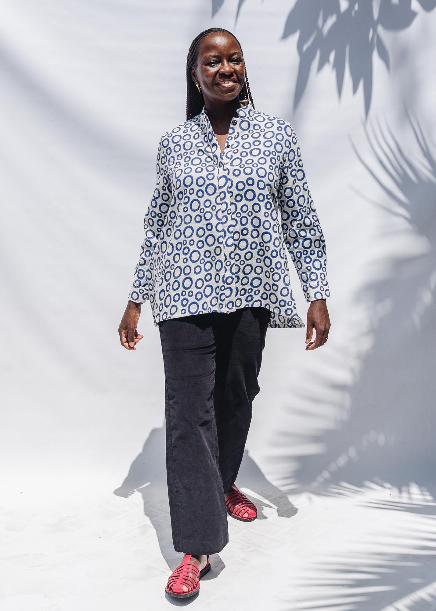 The model is wearing white, blue print shirt