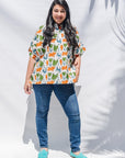 The model is wearing blue, orange, green, brown, white and black print shirt