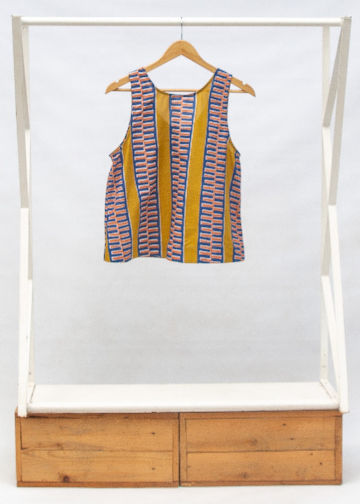 Display of olive-yellow, blue, orange and white geometric printed tank