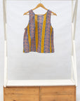 Display of olive-yellow, blue, orange and white geometric printed tank