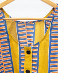 Close up display olive-yellow, blue, orange and white geometric printed tank