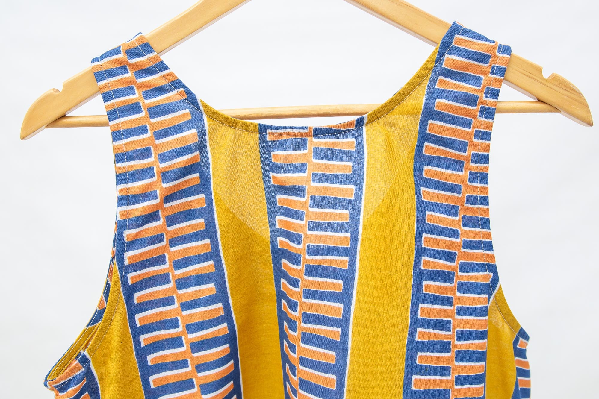 Close up display olive-yellow, blue, orange and white geometric printed tank