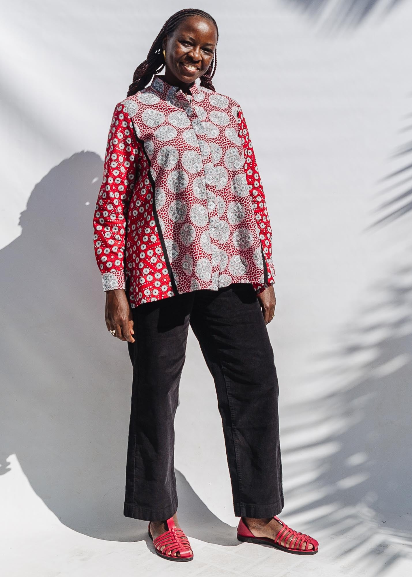 The model is wearing red, black, white print shirt