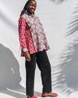 The model is wearing red, black, white print shirt