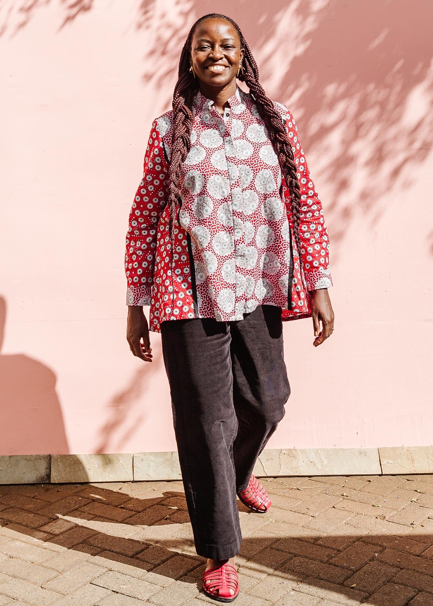 The model is wearing red, black, white print shirt