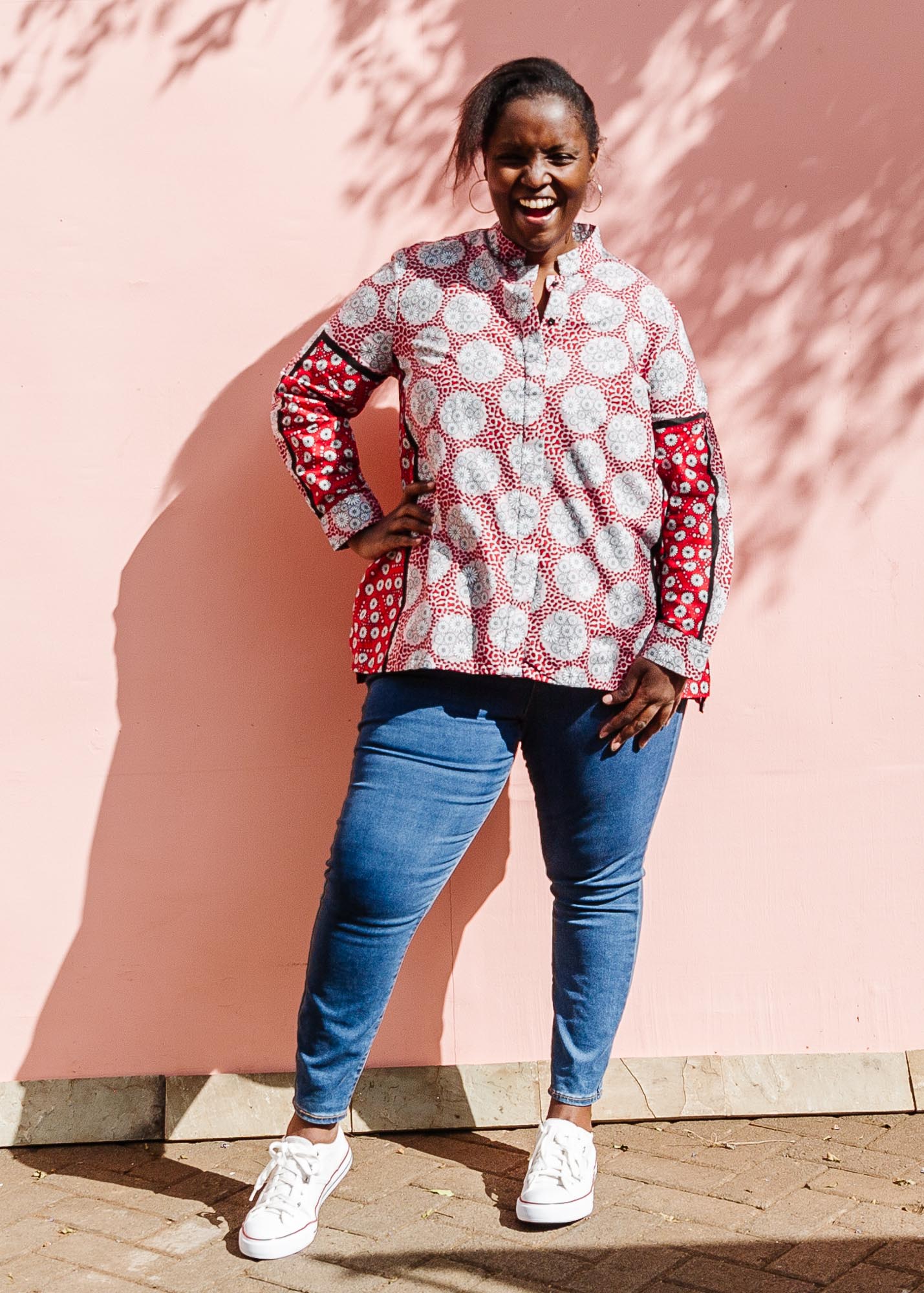 The model is wearing red, black, white print shirt