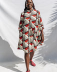 The model is wearing black, red, off white print dress