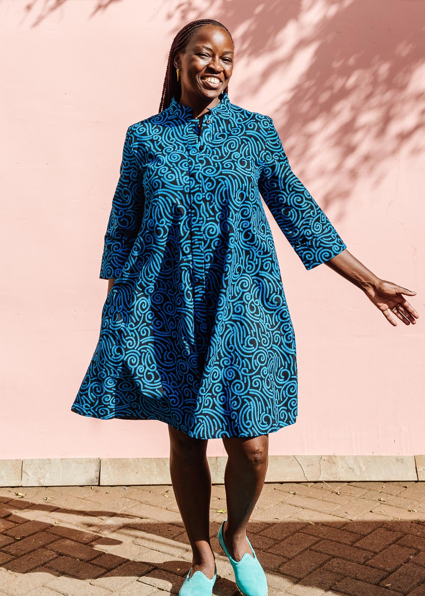 The model is wearing blue and black print dress