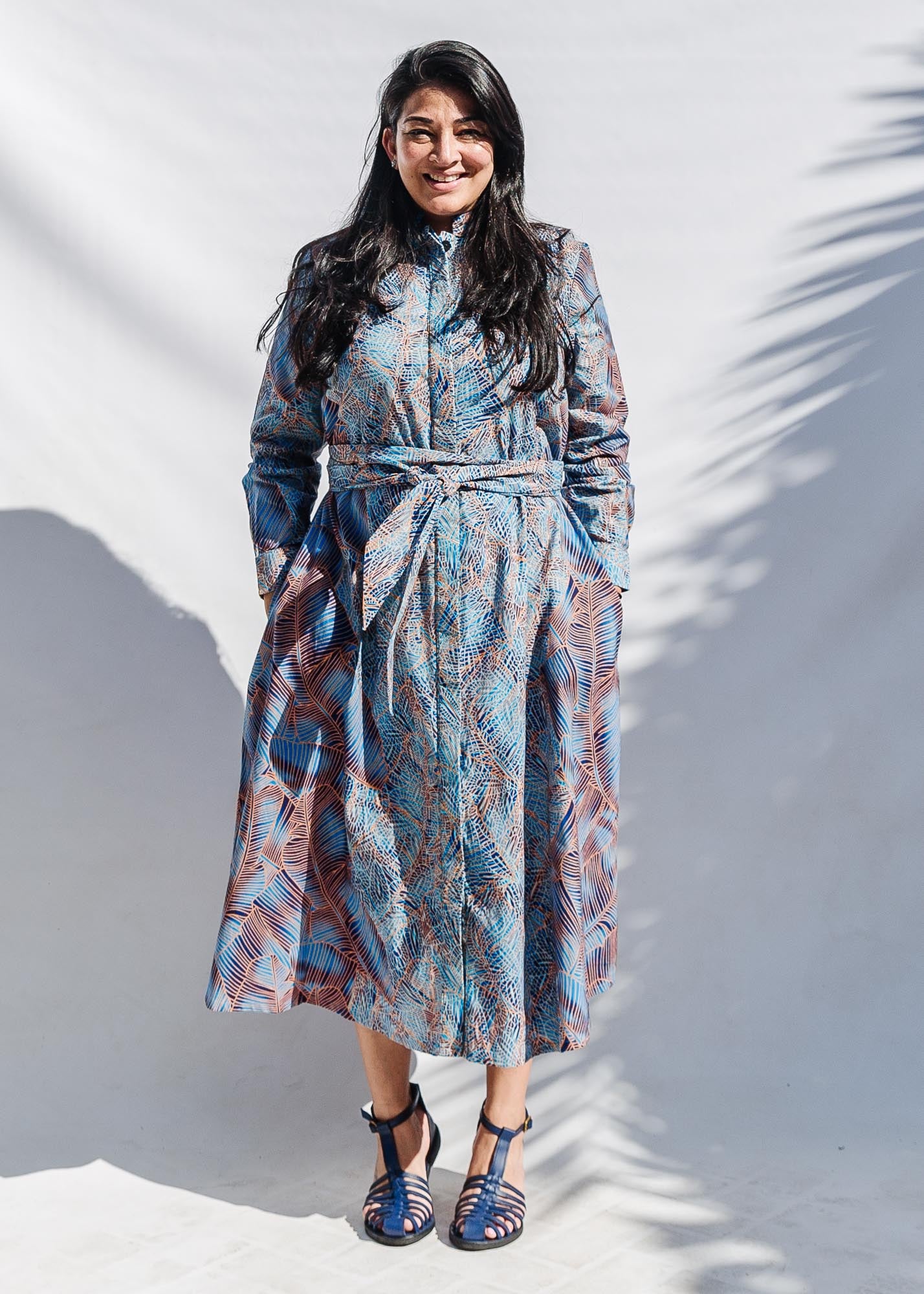 The model is wearing sky blue, blue, orange print dress