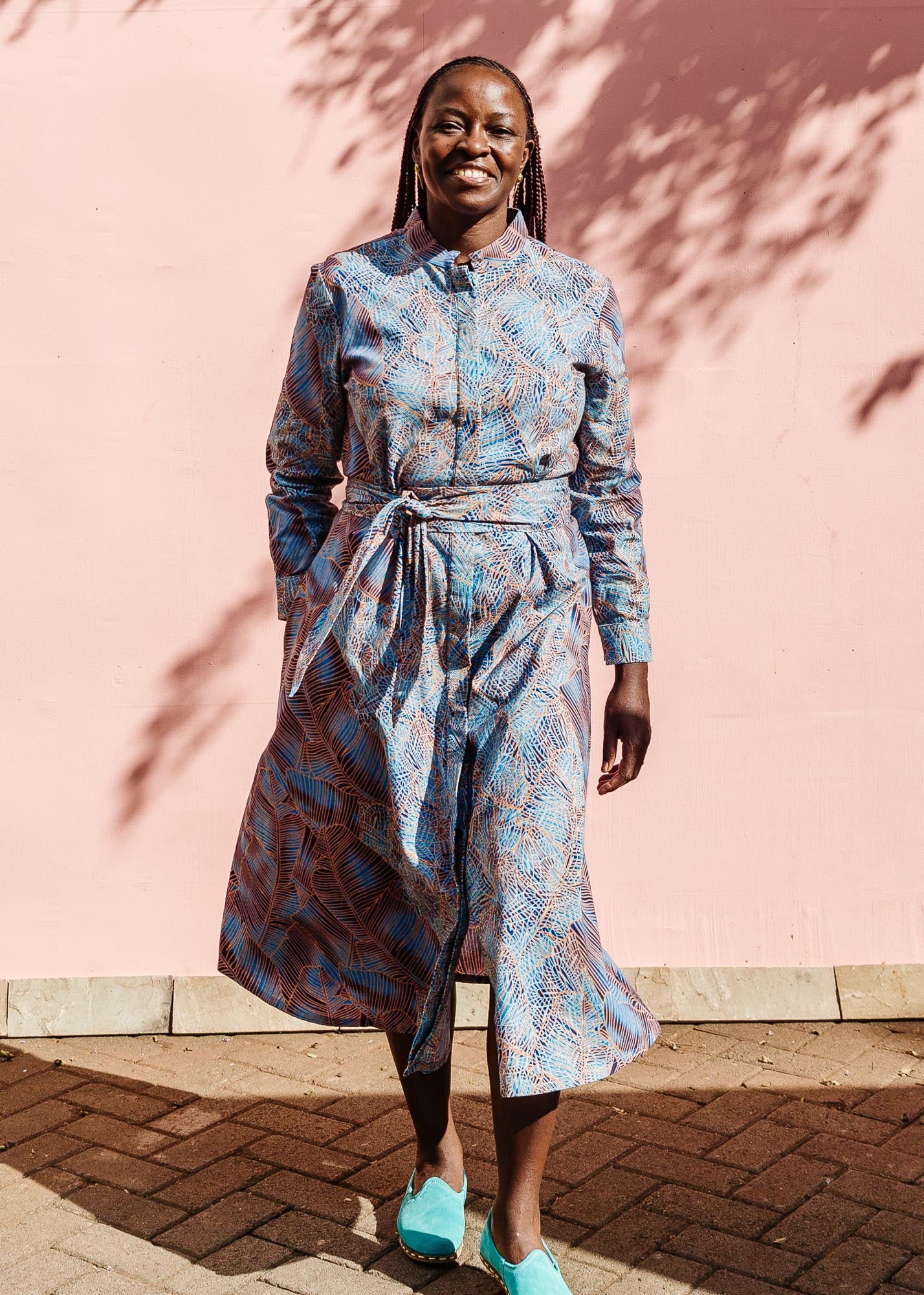 The model is wearing sky blue, blue, orange print dress