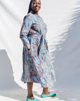 The model is wearing sky blue, blue, orange print dress