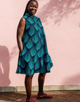 Model wearing blue and black geometric print sleeveless dress