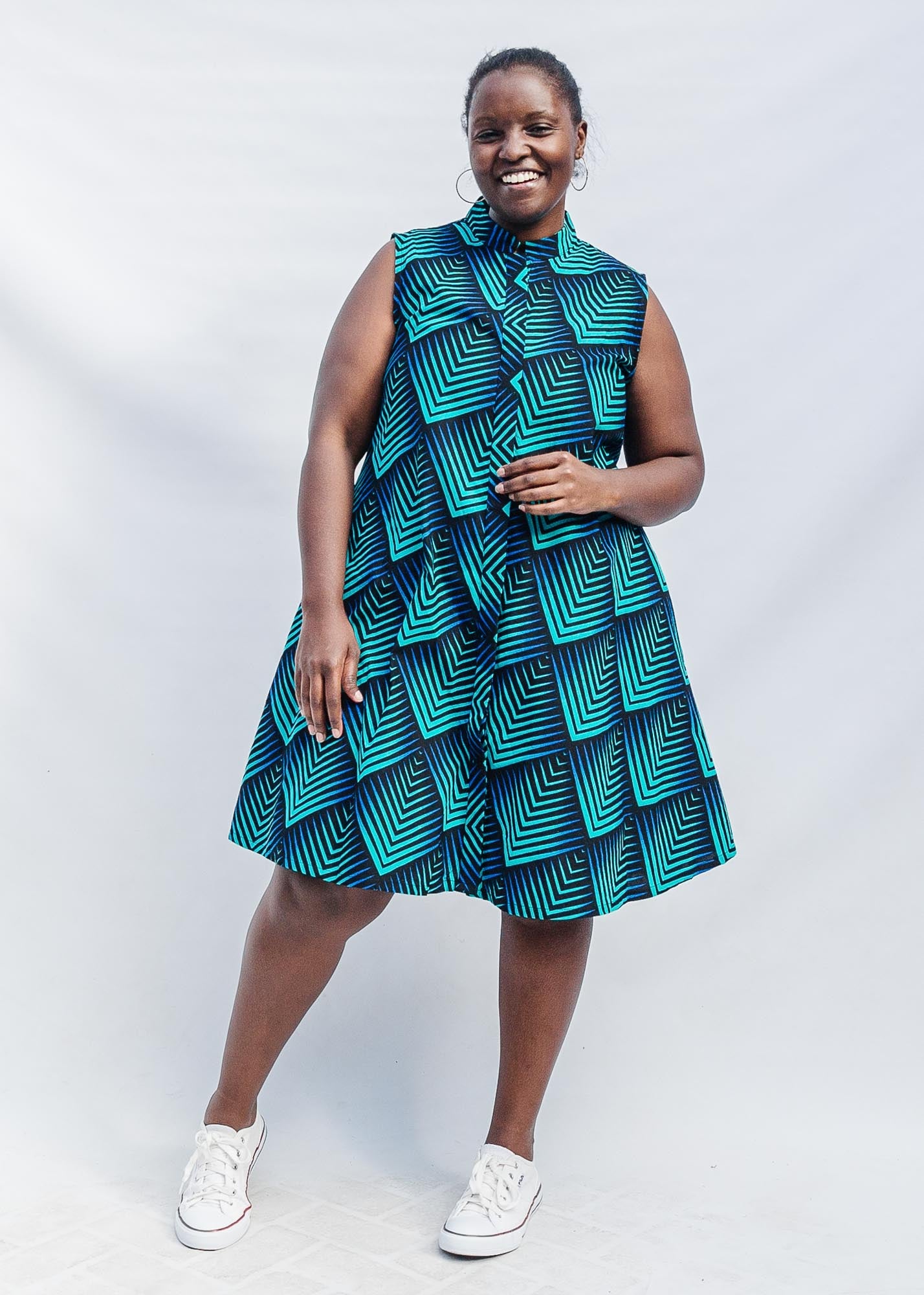 Model wearing blue and black geometric print sleeveless dress