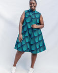 Model wearing blue and black geometric print sleeveless dress