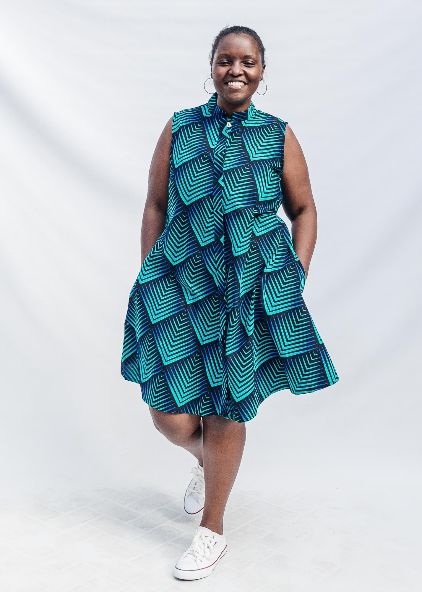 Model wearing blue and black geometric print sleeveless dress