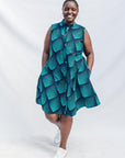 Model wearing blue and black geometric print sleeveless dress