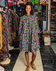 The model is wearing multi colored dress with disco ball print