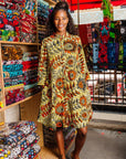 The model is wearing white and chartreuse dress with orange and black sunflowers