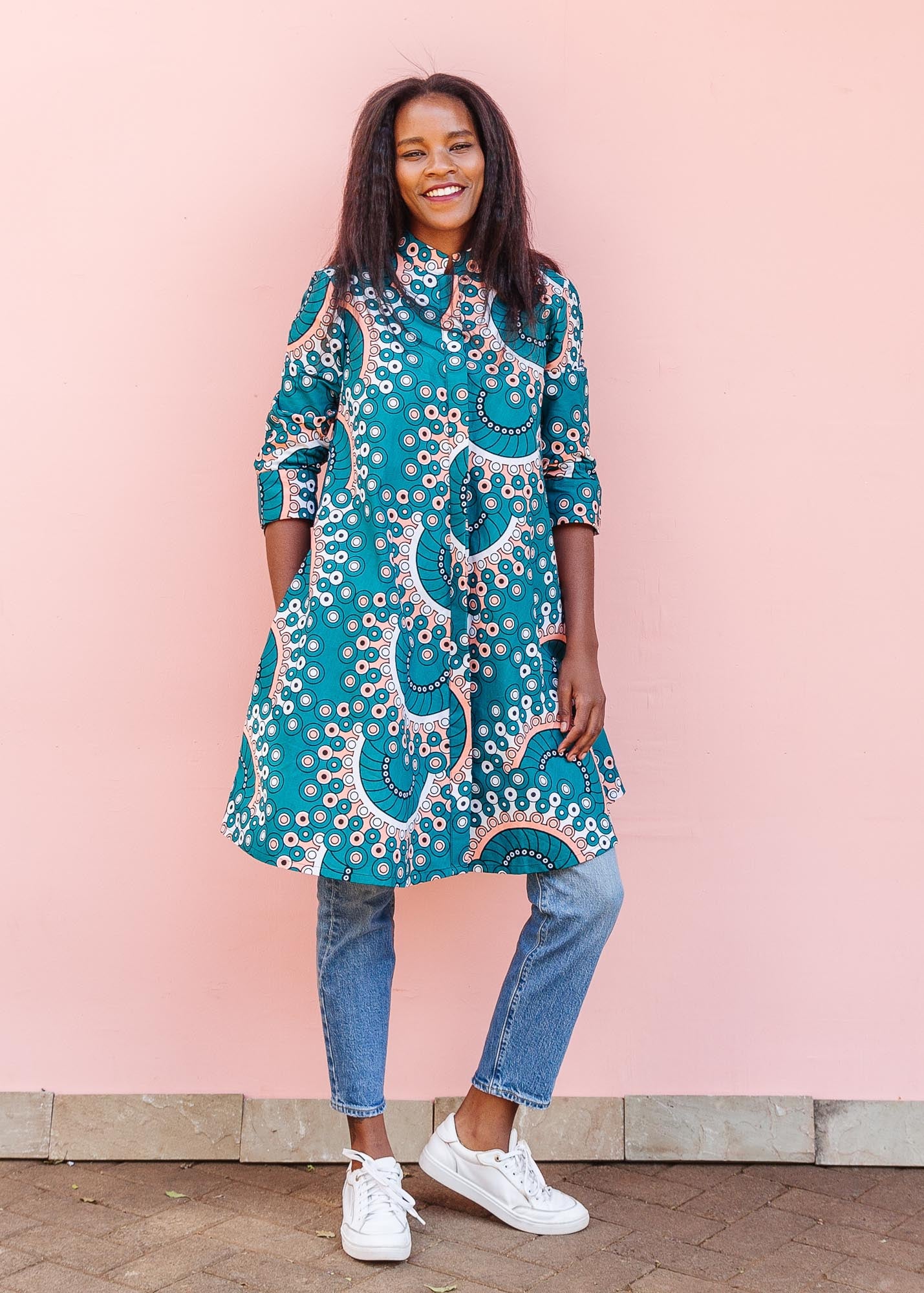 The model is wearing teal, white, black and peach dress with gears