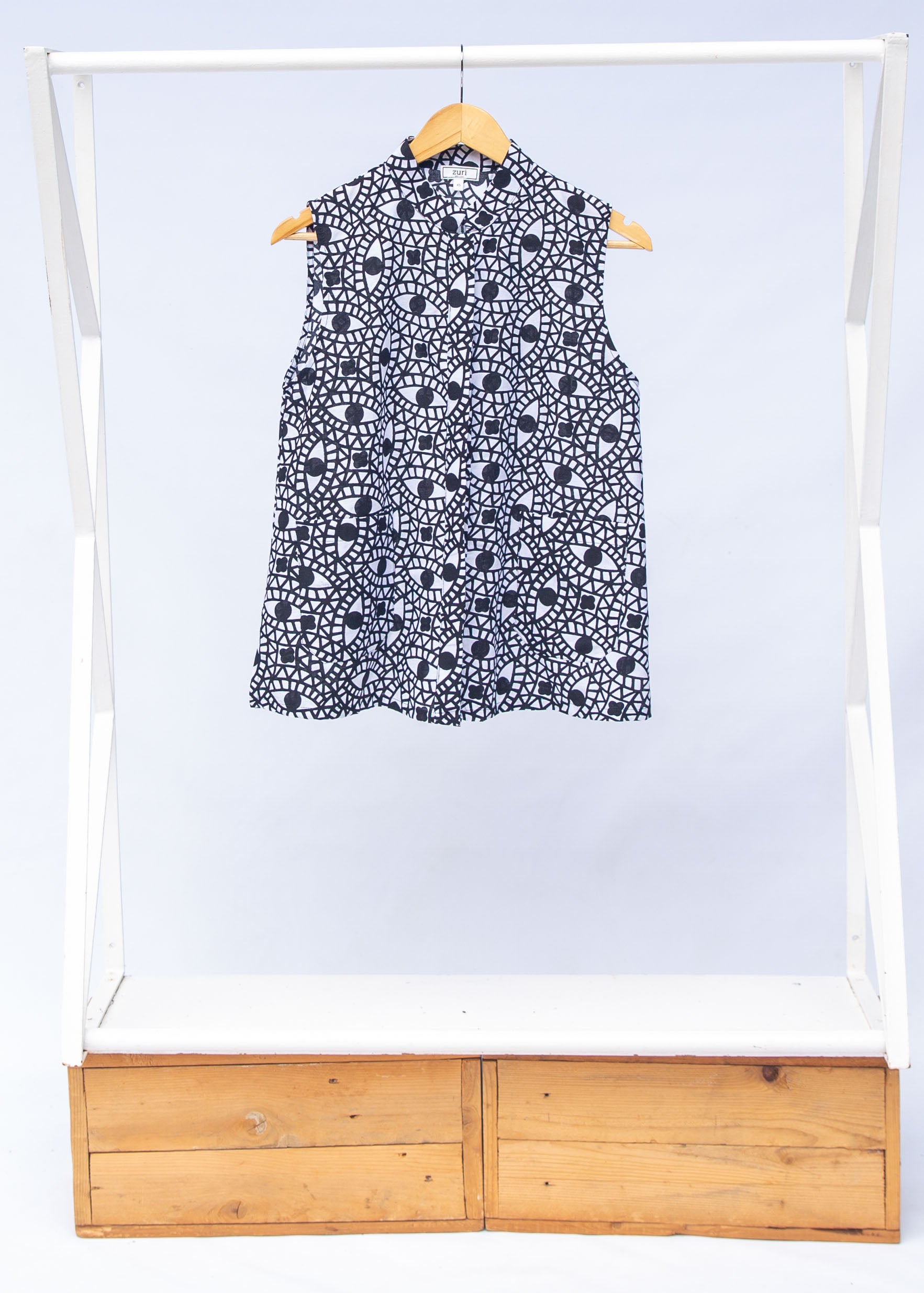 Display of black and white eye print sleeveless shirt.