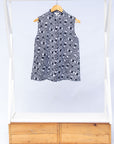 Display of black and white eye print sleeveless shirt.