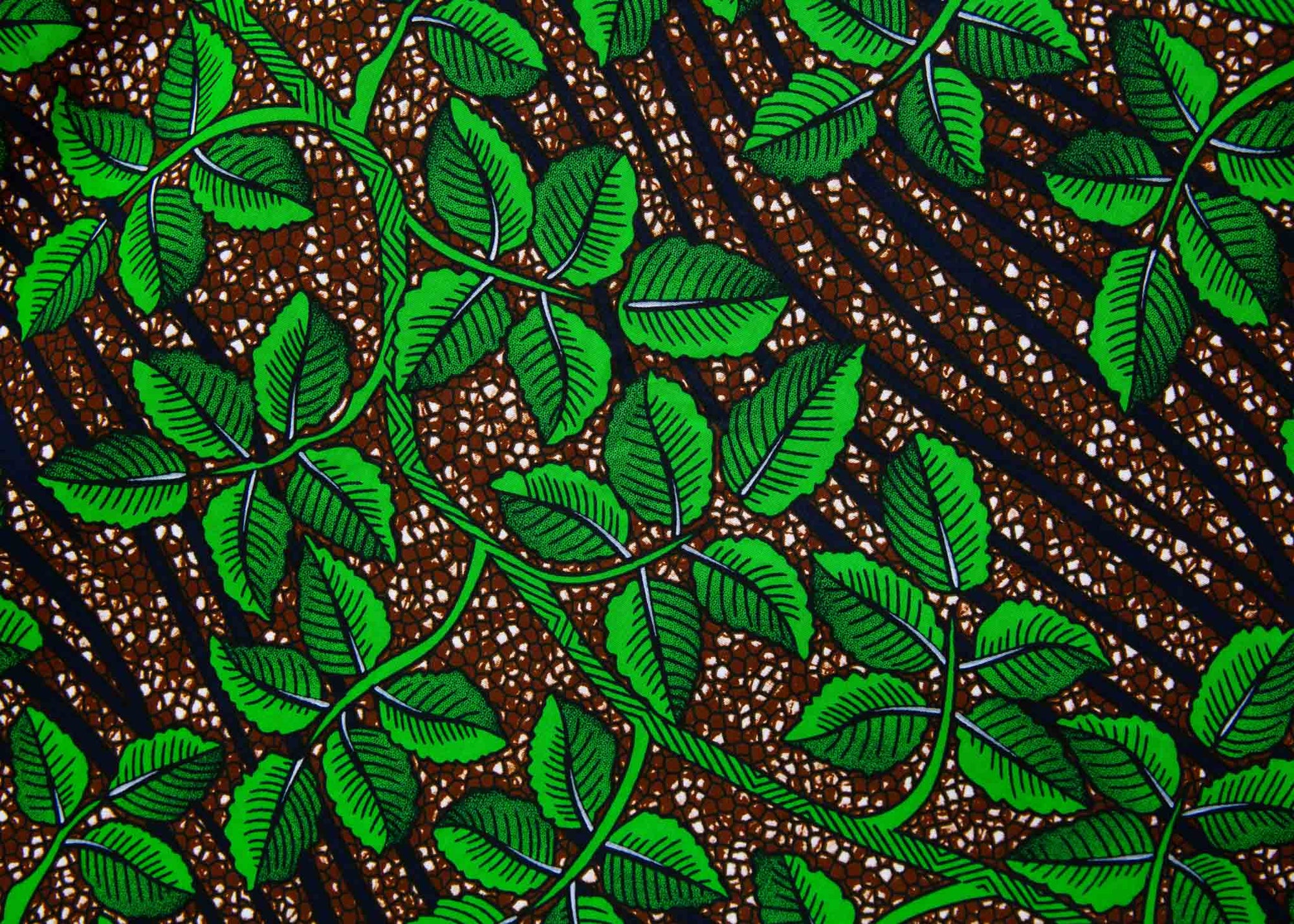 Display of brown dress with green vine print.