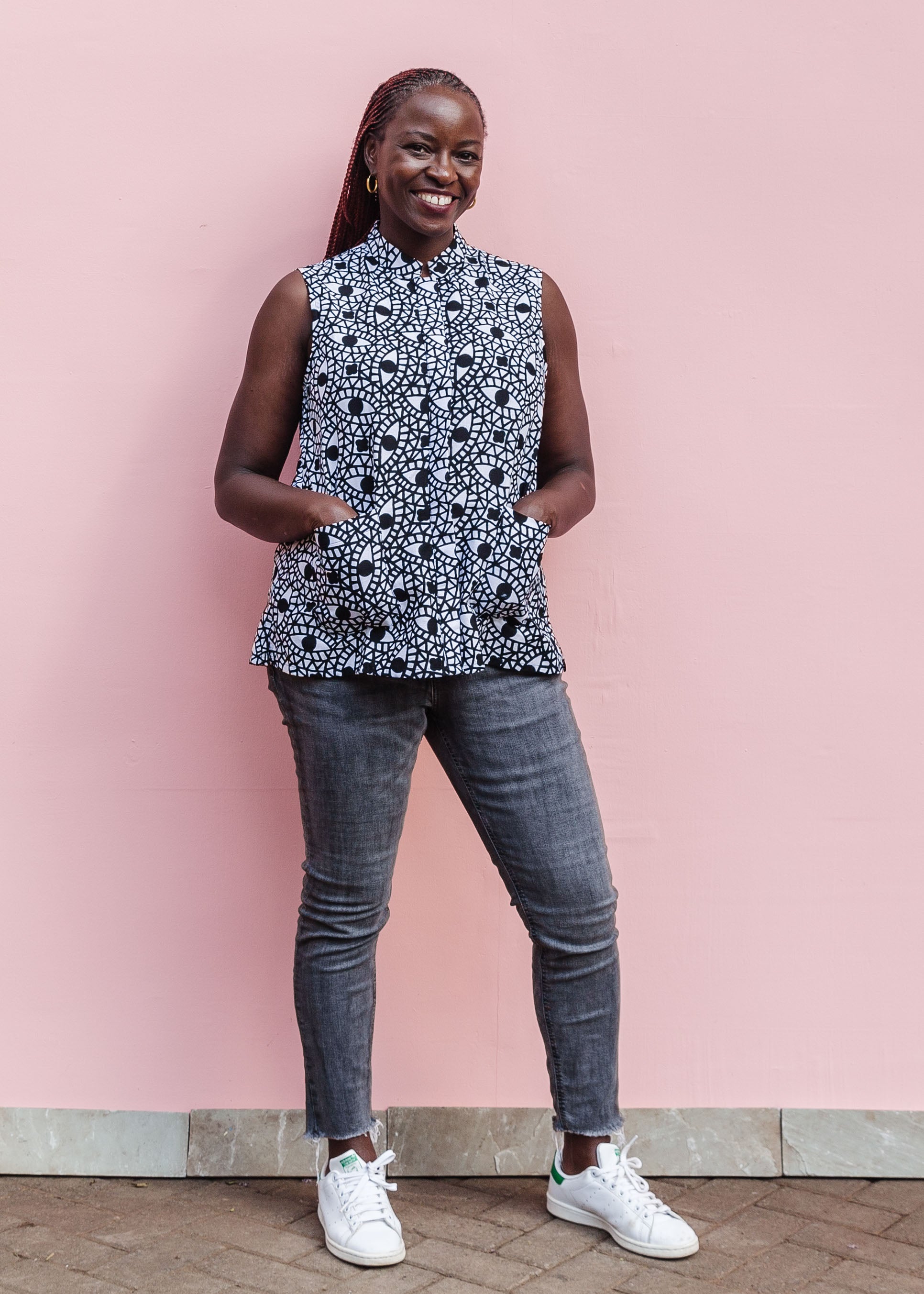 Model wearing black and white eye print sleeveless shirt.