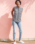 Model wearing black and white eye print sleeveless shirt.