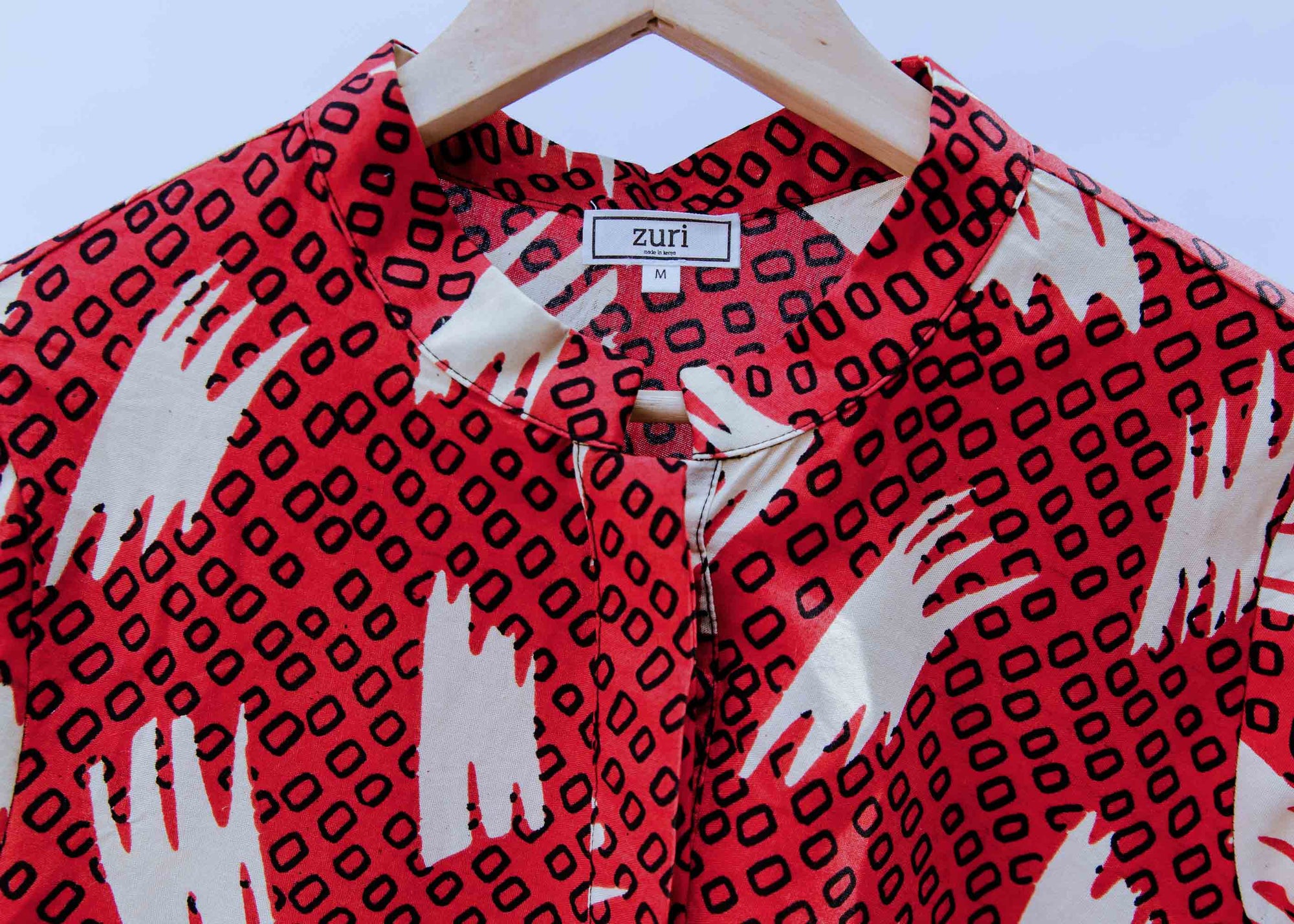 display of a red, white and black squiggle design dress