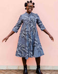 model wearing a black and white palm tree design dress