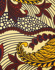 Close up display of paisley print dress with hues of brown.