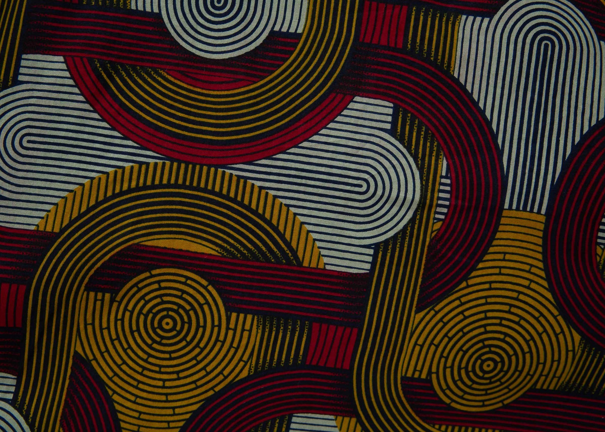 Close up display of red, yellow, gray and black dress with abstract line print.