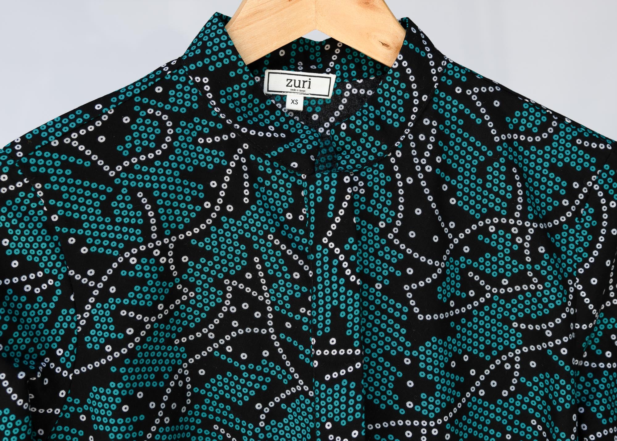 detail of teal printed shirt dress