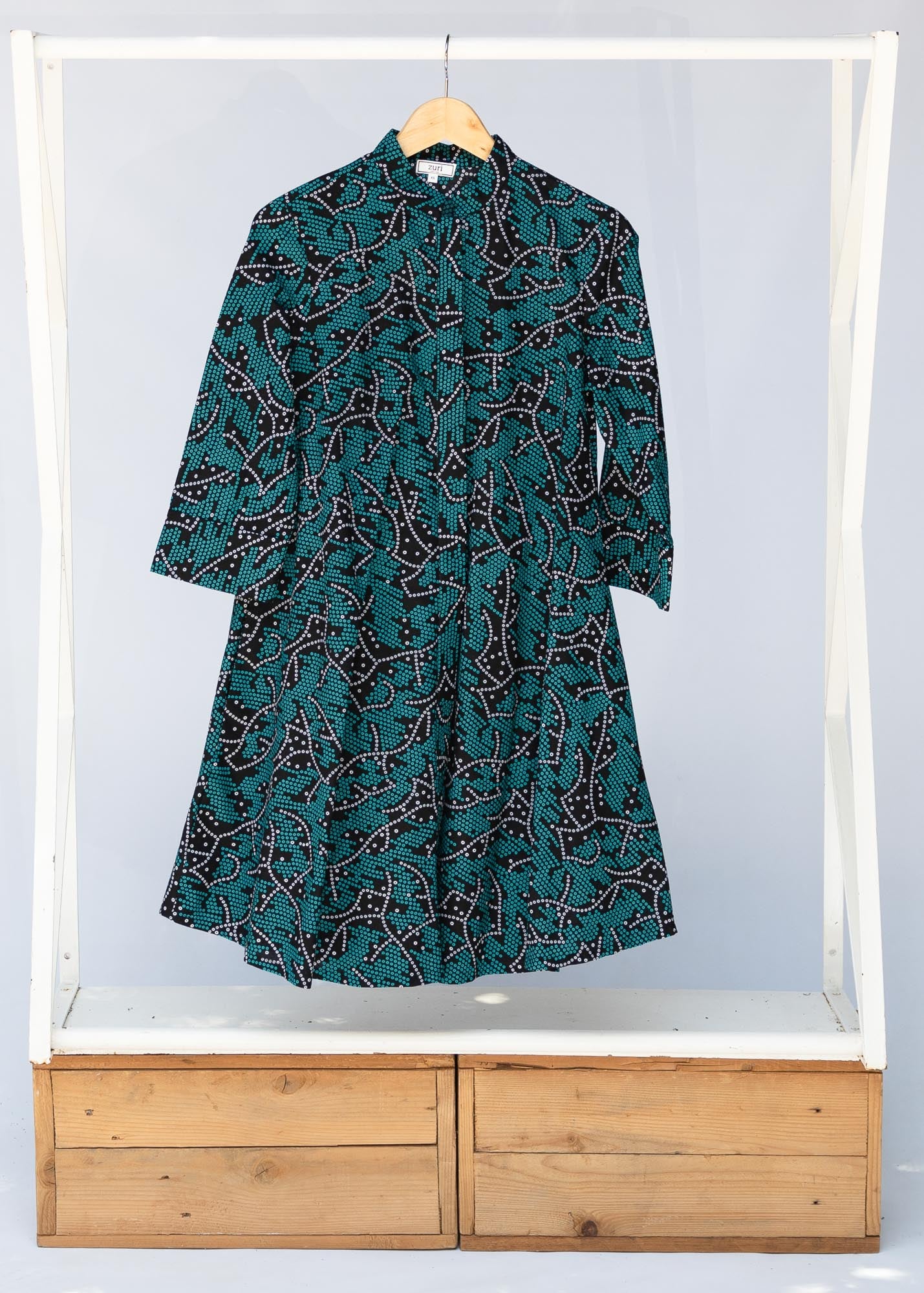 teal printed shirt dress shown on rack