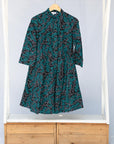 teal printed shirt dress shown on rack