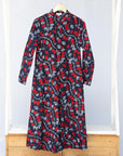 a red and navy midi length dress on a rack