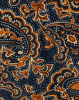 detail of a midi-length belted paisley dress