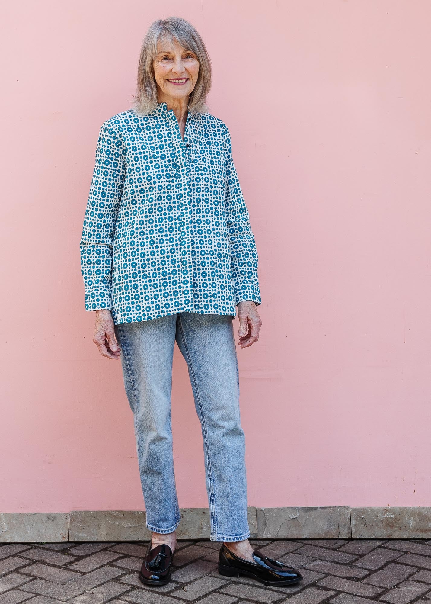 model wearing teal and white block printed long sleeved shirt