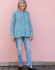 model wearing teal and white block printed long sleeved shirt