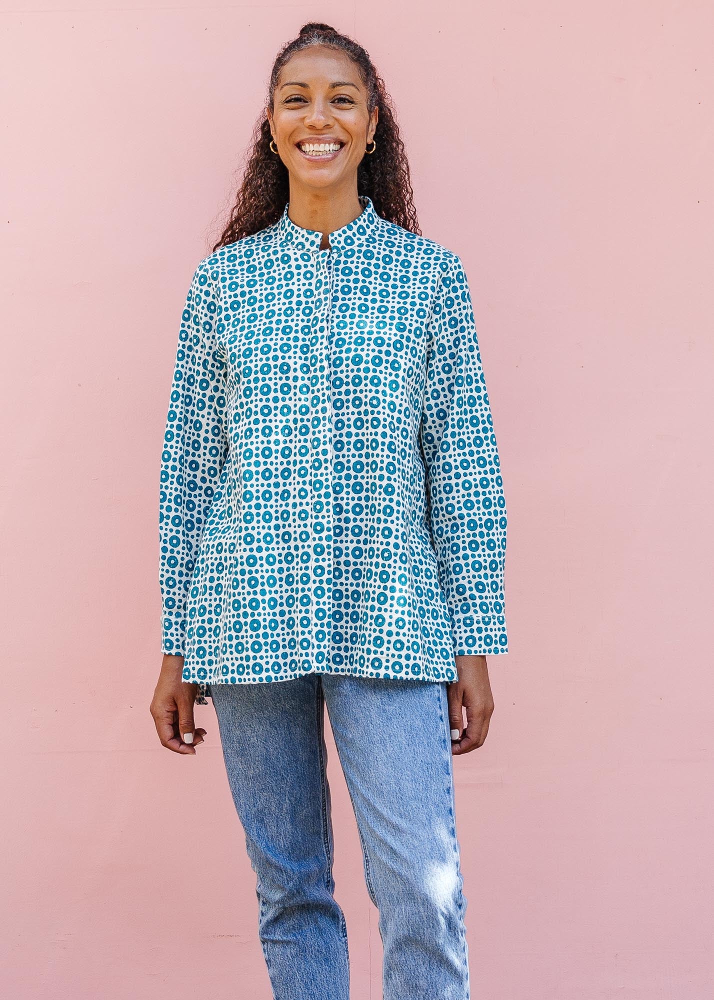 model wearing teal and white block printed long sleeved shirt