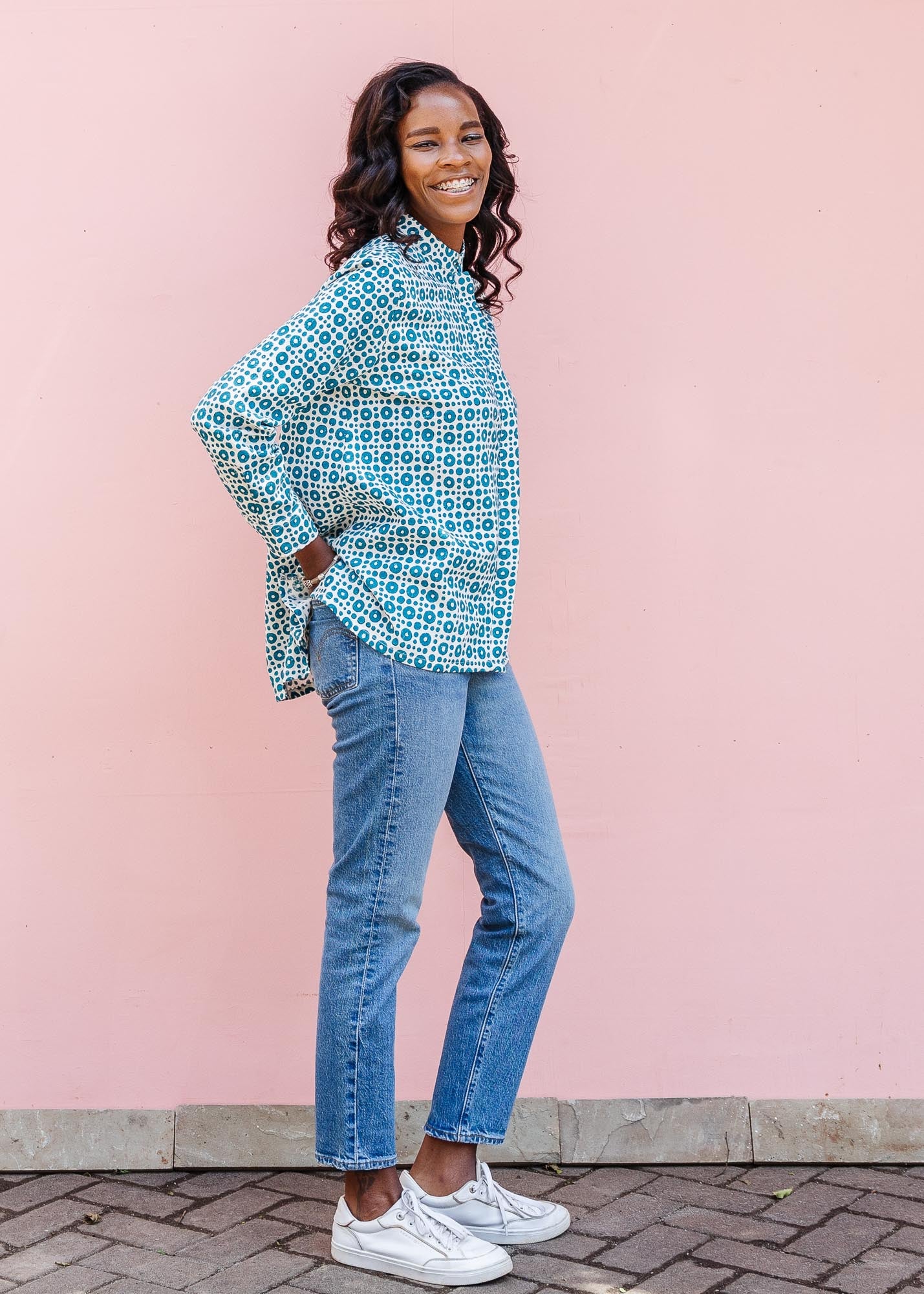 model wearing teal and white block printed long sleeved shirt