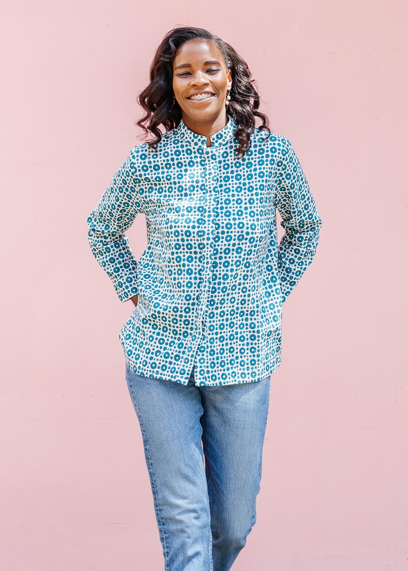 model wearing teal and white block printed long sleeved shirt