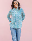 model wearing teal and white block printed long sleeved shirt